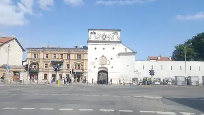 a large white building with a clock tower on a street at senamiescio deimantas in Vilnius