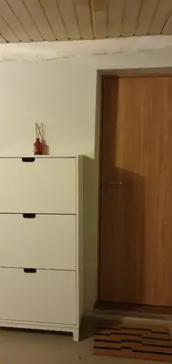 a room with a dresser and a wooden door at senamiescio deimantas in Vilnius