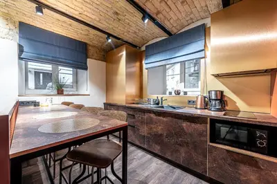 a kitchen with a counter and a counter top at UNESCO Hidden Arches – Restored 3 Bedroom Apartment in the Historic Pilies St. in Vilnius