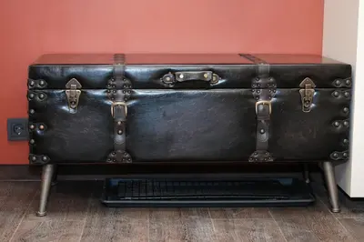 an old suitcase sitting on top of a table at UNESCO Hidden Arches – Restored 3 Bedroom Apartment in the Historic Pilies St. in Vilnius