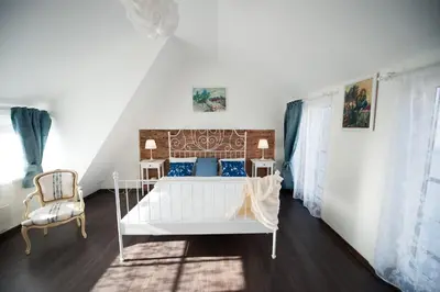 a bedroom with a white bed and a chair at Vilnius Old Town, 3 BDR Penthouse, 100 m2 with Terrace in Vilnius
