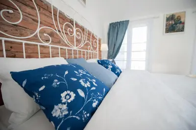 a bed with blue and white pillows in a bedroom at Vilnius Old Town, 3 BDR Penthouse, 100 m2 with Terrace in Vilnius