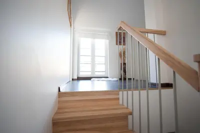 a staircase in a house with a window at Vilnius Old Town, 3 BDR Penthouse, 100 m2 with Terrace in Vilnius