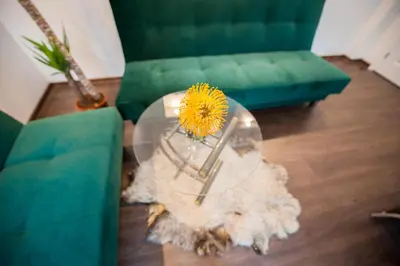 a living room with a table with a yellow flower on it at Vilnius Old Town, 3 BDR Penthouse, 100 m2 with Terrace in Vilnius