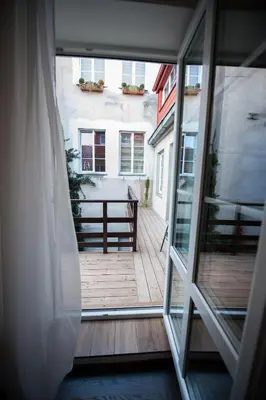 a view of a balcony from an open window at Vilnius Old Town, 3 BDR Penthouse, 100 m2 with Terrace in Vilnius