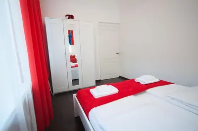 a room with a bed with a red blanket and a mirror at Romantic New 2 Bedroom Vilnius Best Location in Vilnius