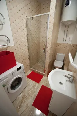 a bathroom with a washing machine and a sink at Romantic New 2 Bedroom Vilnius Best Location in Vilnius