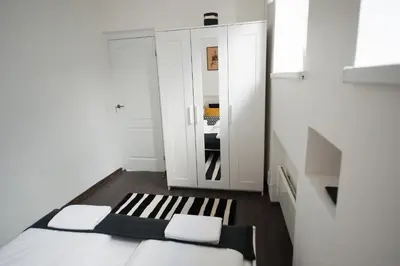 a small room with two beds and a cabinet at Romantic New 2 Bedroom Vilnius Best Location in Vilnius