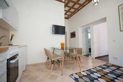 a kitchen with a table and chairs in a room at Romantic New 2 Bedroom Vilnius Best Location in Vilnius