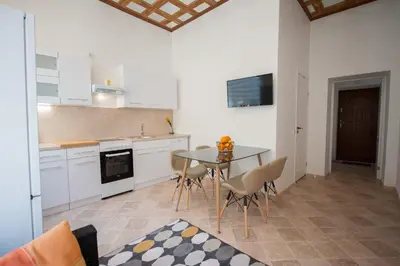 a kitchen with a table and chairs in a room at Romantic New 2 Bedroom Vilnius Best Location in Vilnius