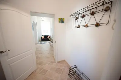 a hallway with a white door and a room at Romantic New 2 Bedroom Vilnius Best Location in Vilnius