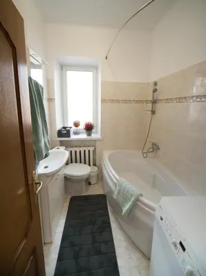 a bathroom with a tub and a toilet and a sink at Petro delux apartments center in Kaunas