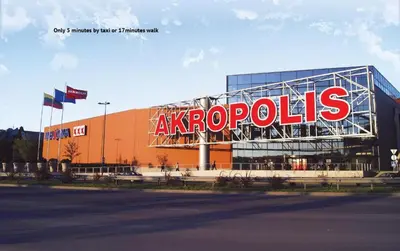 a building with a large sign on the side of it at Petro delux apartments center in Kaunas