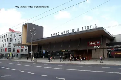 a building on a street with people walking on the sidewalk at Petro delux apartments center in Kaunas