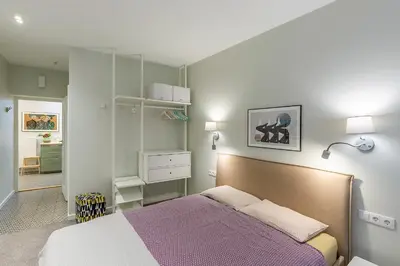 a bedroom with a bed with a purple blanket at Art & Comfort Rooms in Kaunas
