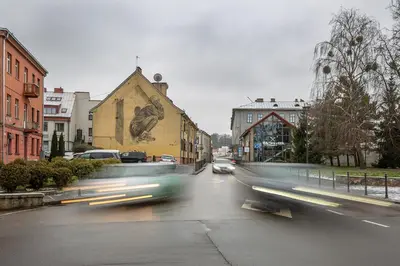 a group of cars driving down a city street at Art & Comfort Rooms in Kaunas