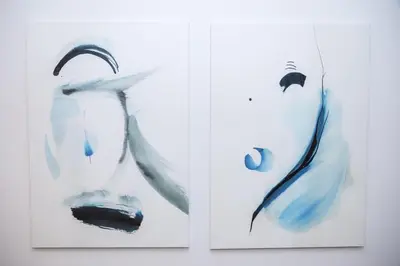 two pieces of art hanging on a wall at Apartment Hotel Laisve in Druskininkai