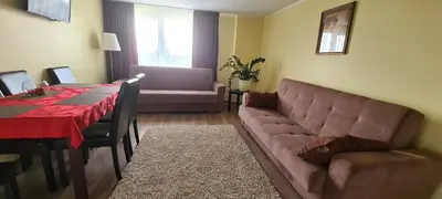 a living room with a couch and a table at Sauliaus apartamentai VIP in Panevėžys