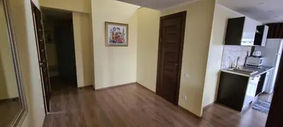 a room with a hallway with a kitchen and a refrigerator at Sauliaus apartamentai VIP in Panevėžys