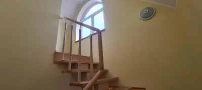 a staircase with a window and a clock on the wall at Sauliaus apartamentai VIP in Panevėžys