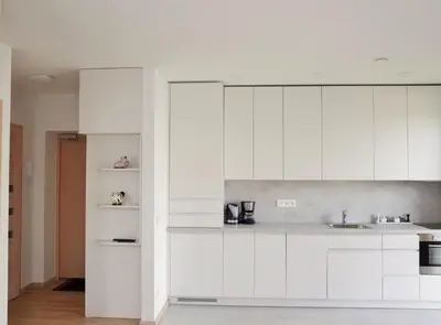 a kitchen with white cabinets and a sink at Elzbietos centro apartamentai in Vilnius