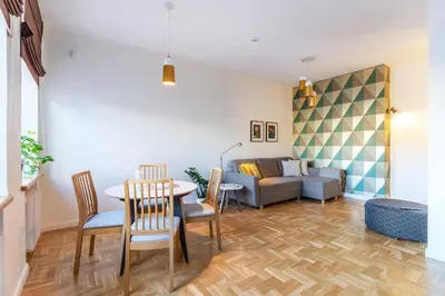 a living room with a table and a couch at Art & Comfort Home in Kaunas