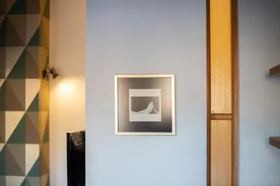 a white hallway with a picture on a wall at Art & Comfort Home in Kaunas