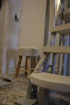a pair of wooden stools sitting in a room at DP Art Residence - self check in in Kaunas