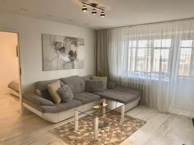 a living room with a couch and a table at Trakų street Apartment in Šiauliai