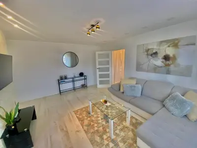 a living room with a couch and a table at Trakų street Apartment in Šiauliai