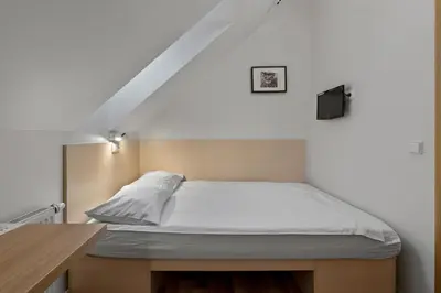 a bed in a room with a white bedvisor at Stay Express in Vilnius