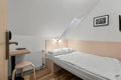 a room with a bed and a desk and a chair at Stay Express in Vilnius