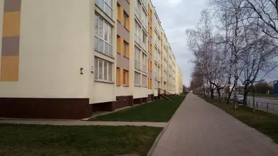 an empty sidewalk in front of a building at Bright apartment on top in Panevėžys