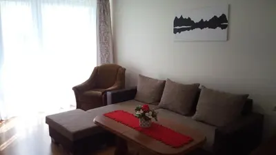 a living room with a couch and a table at Bright apartment on top in Panevėžys
