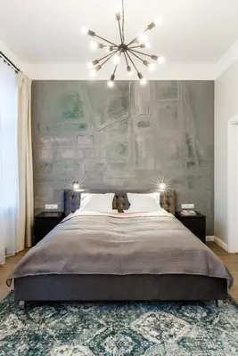 a bedroom with a large bed with a large wall at Laisves ave. Apartments in Kaunas