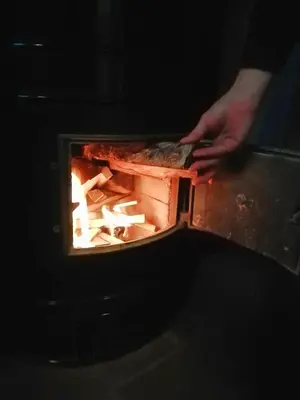 a person is cooking food in an oven at Sauna2relax in Šveicarija