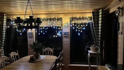 a dining room with a table and christmas lights at Sauna2relax in Šveicarija