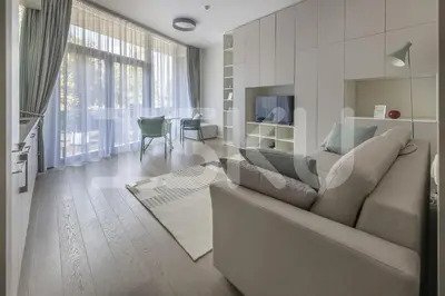 a living room with a couch and a table at Mint Studio in Druskininkai