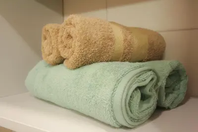 a stack of towels on a counter in a bathroom at Mint Studio in Druskininkai