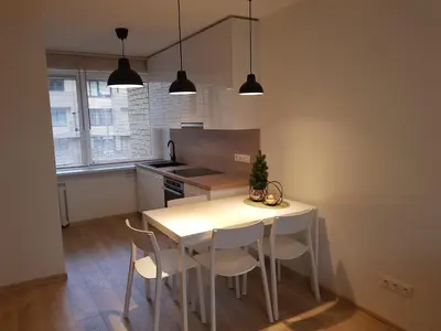 a kitchen with a white table and chairs at New CITY CENTER apartments in Druskininkai