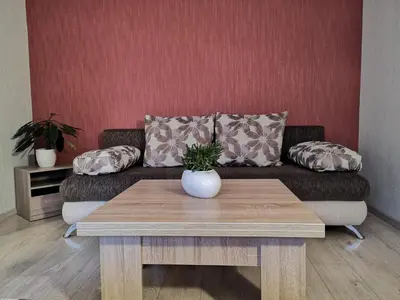 a living room with a couch and a table at Raudondvario II in Kaunas
