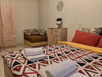 a bedroom with a bed with towels on it at Raudondvario II in Kaunas