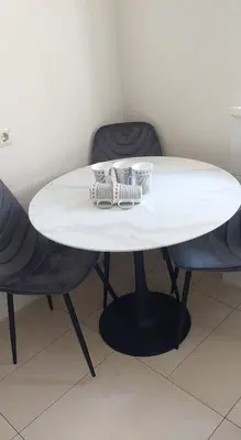 a white table with two chairs and two cups on it at Raudondvario II in Kaunas