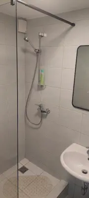 a bathroom with a shower and a sink at Kalniečiai park apartment in Kaunas