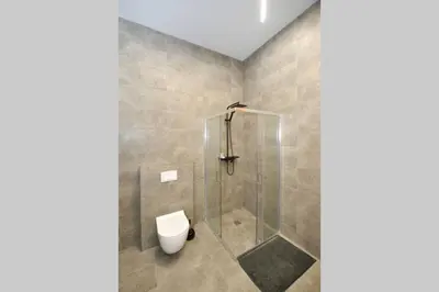 a bathroom with a shower and a toilet in it at Šalia Kauno centro in Kaunas