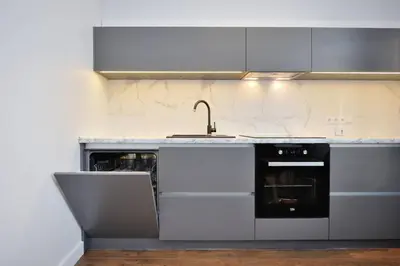 a kitchen with a sink and a stove at Šalia Kauno centro in Kaunas
