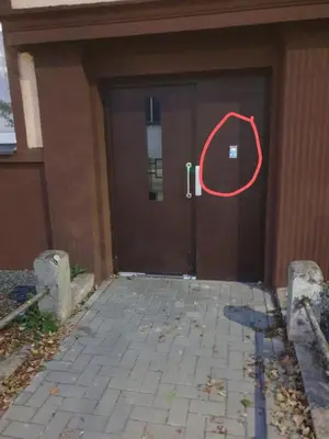 a door to a building with a red circle on it at Šalia Kauno centro in Kaunas