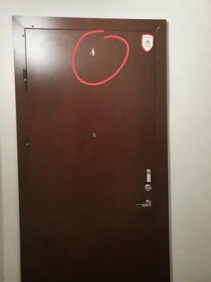a brown door with a red circle on it at Šalia Kauno centro in Kaunas