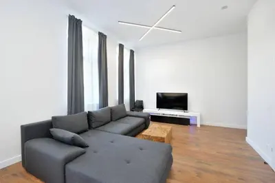 a living room with a couch and a tv at Šalia Kauno centro in Kaunas