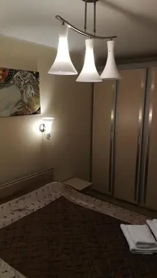 a room with three lights hanging from the ceiling at Jaukus butukas in Druskininkai